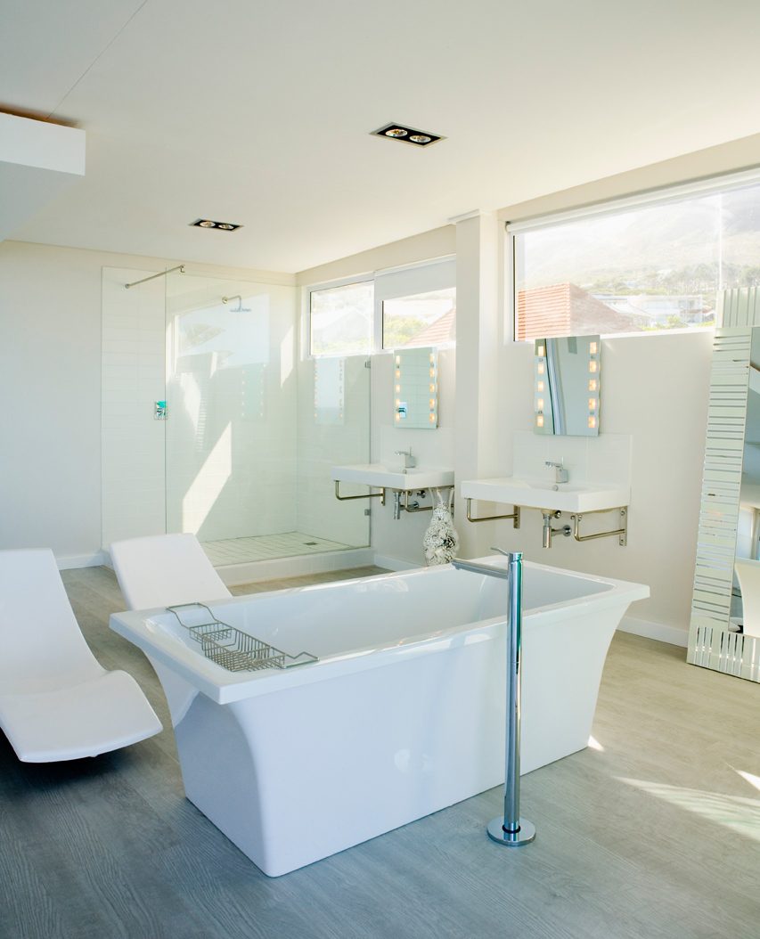 Clean modern bathroom with freestanding tub — fixture and finish plumbing by Sullivan & Sons